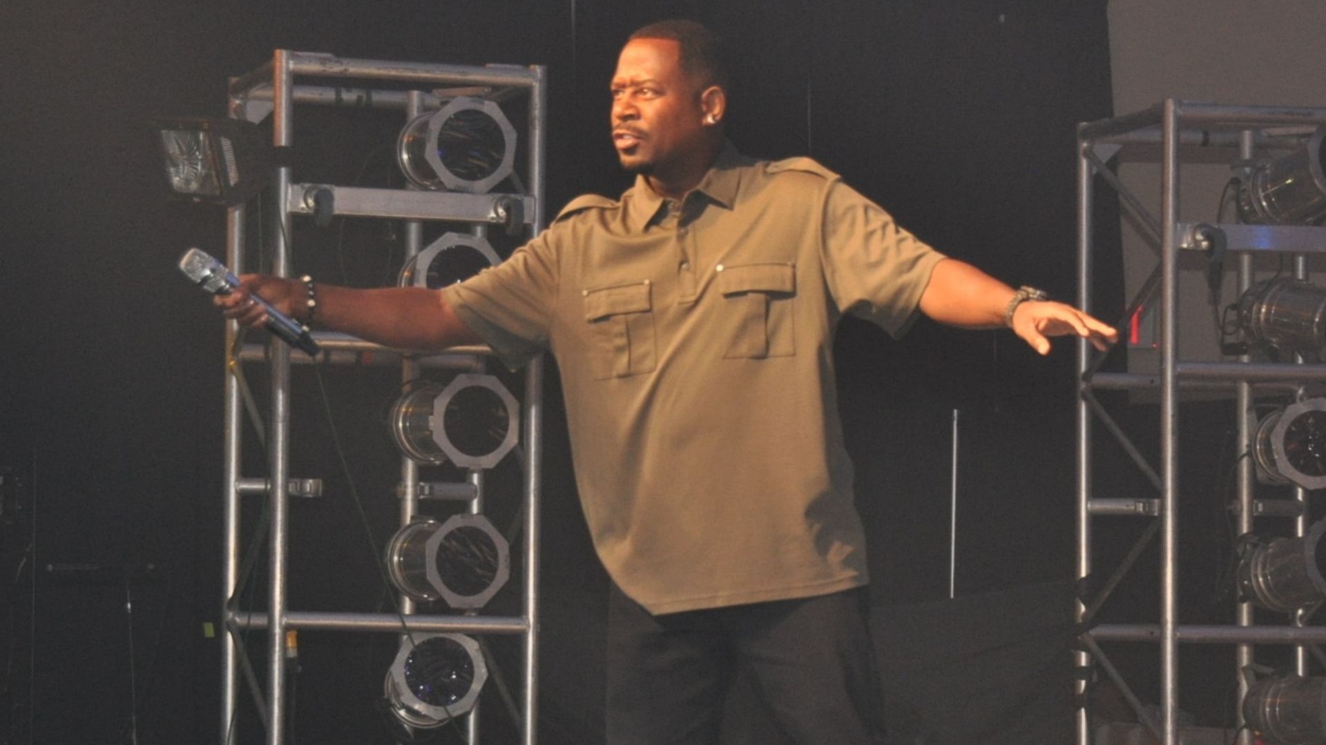 Photograph of Martin Lawrence holding the microphone to an audience of US Air Force troops at Centennial Banquet and Conference Center East Fort Bliss Texas as part of the Tour of the Troops show