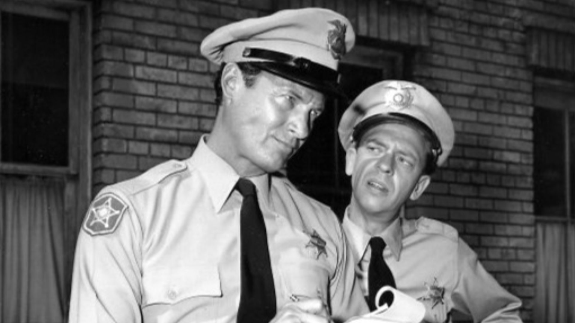 Photo of Don Knotts (Barney Fife) and Mark Miller from the television program The Andy Griffith Show.  In this episode, Miller plays a law officer who is sent to Mayberry for training; Barney assumes this is not the temporary situation it's said to be and