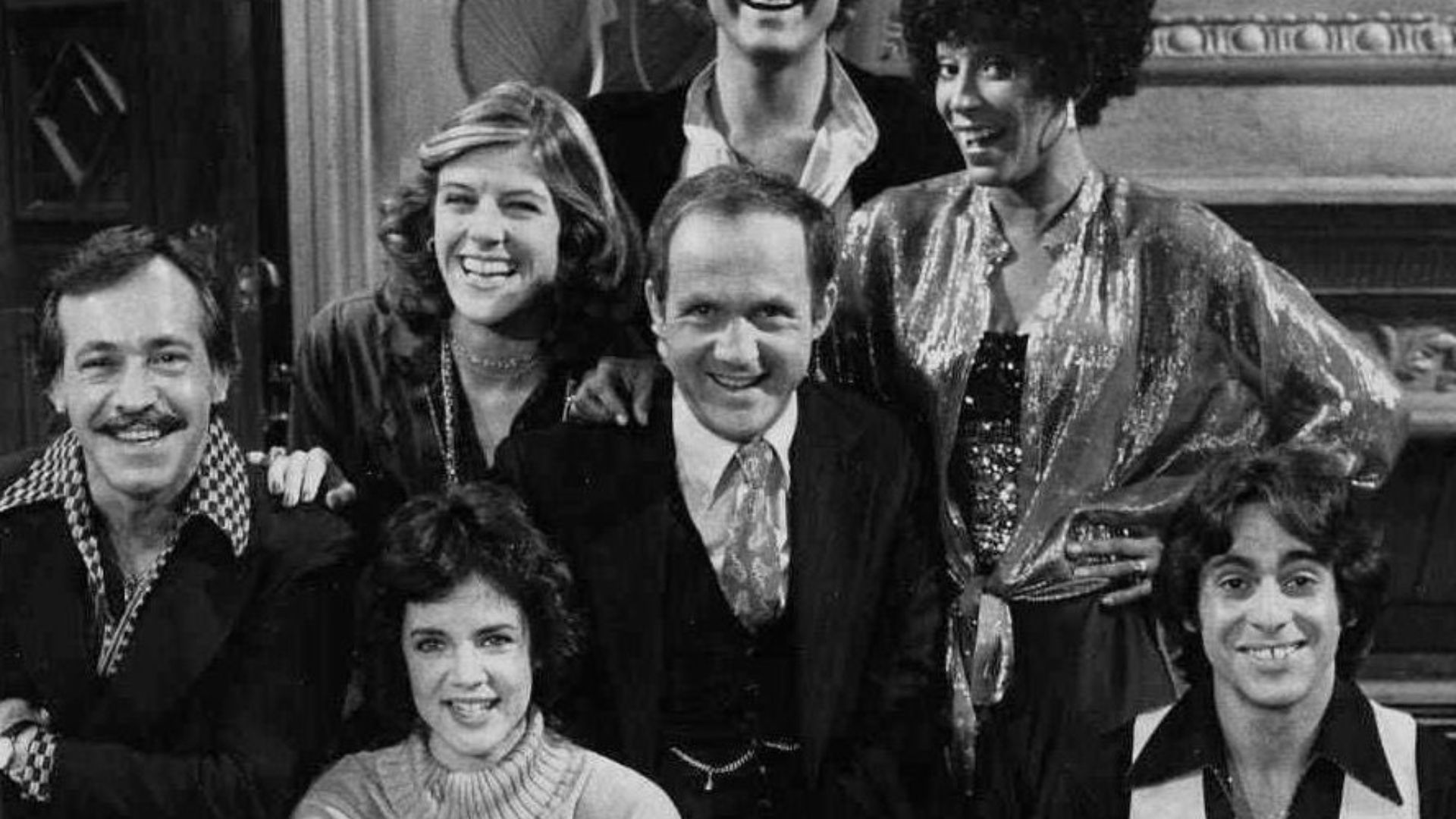 Stockard Channing (seated, front row left) as Susan Hughes, a newcomer to Los Angeles trying to make a new life, is surrounded by, counter-clock- wise, Albert Insinnia (as Angelo, her boss's son), Sydney Goldsmith (as Coral, her co-worker), Gerrit Graham 