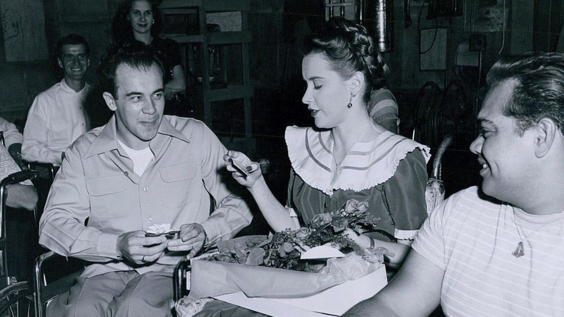 Susan Peters visited by the Paralyzed Veterans Association on the set of The Sign of the Ram, 1948