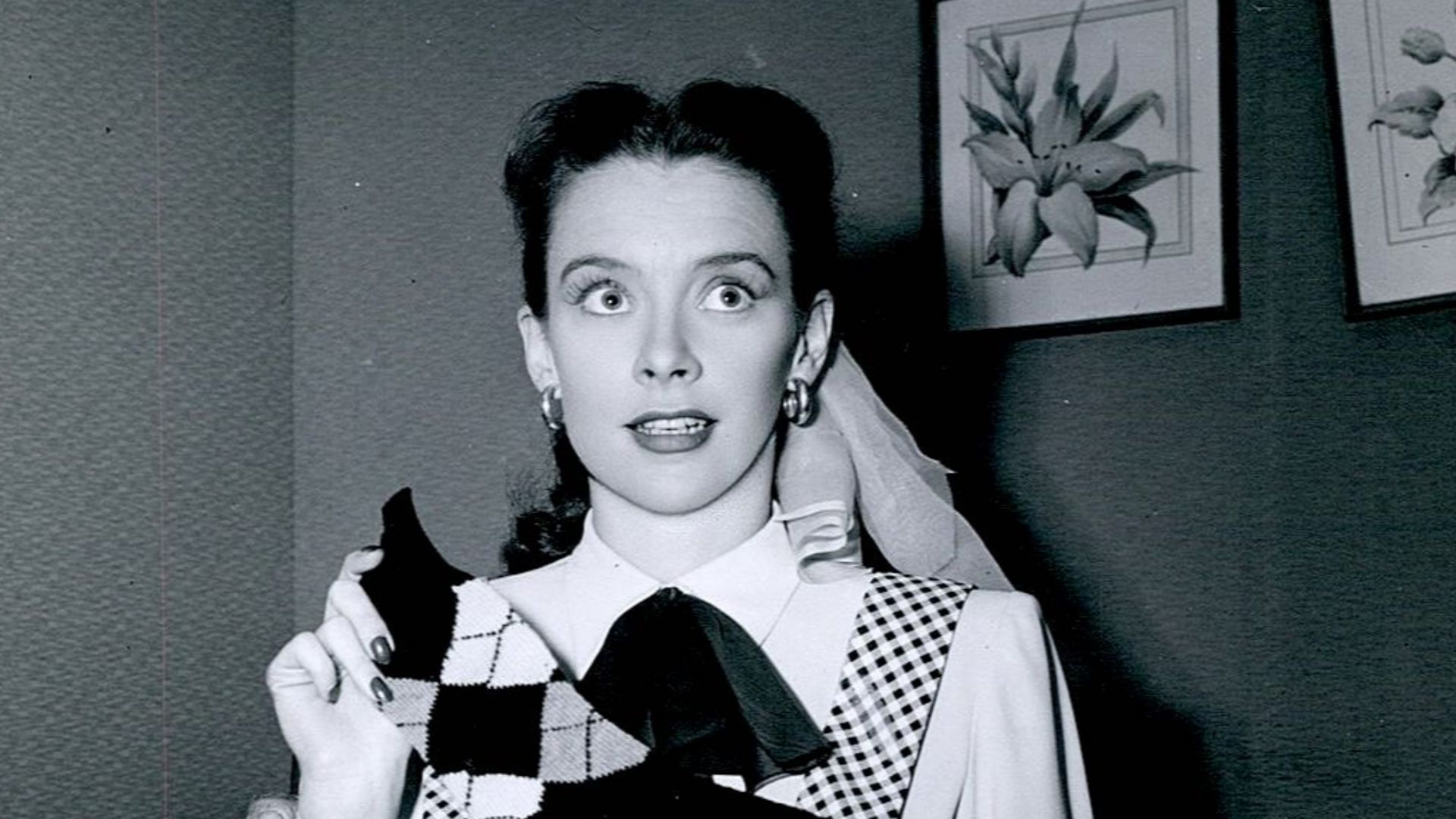 Susan Peters with knitted sock she made on the set of The Sign of the Ram