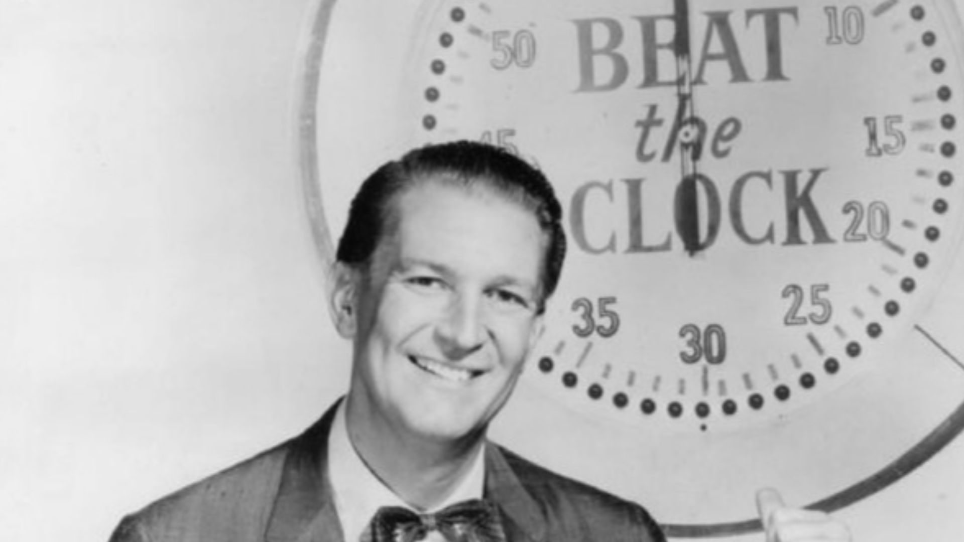 Photo of Bud Collyer as the host of the television program Beat the Clock.