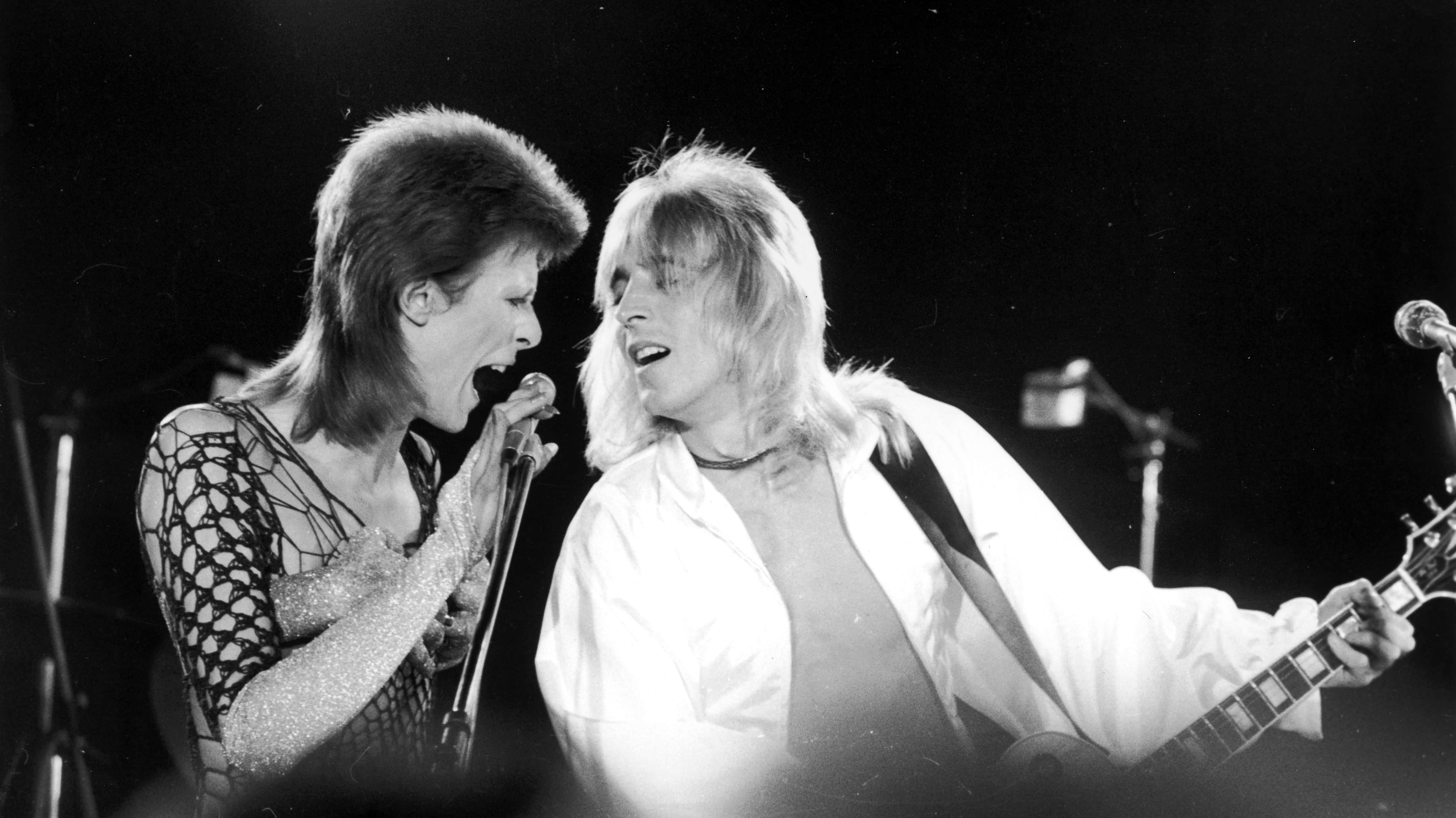 David Bowie (1947 - 2016, left) performing with guitarist Mick Ronson (1946 1993) at a live recording of 'The 1980 Floor Show' for the NBC 'Midnight Special' TV show, at The Marquee Club in London, with a specially invited audience of Bowie fanclub members, 20th October 1973.