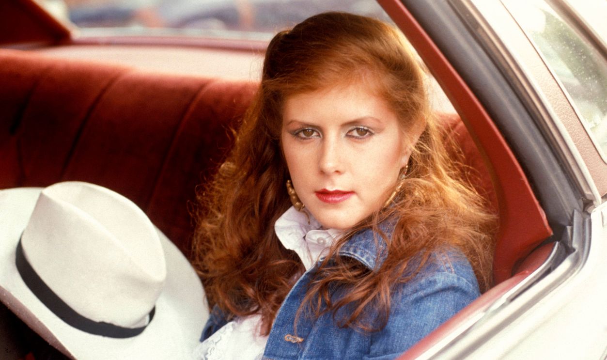 Photo of Kirsty MacCOLL; posed, in car