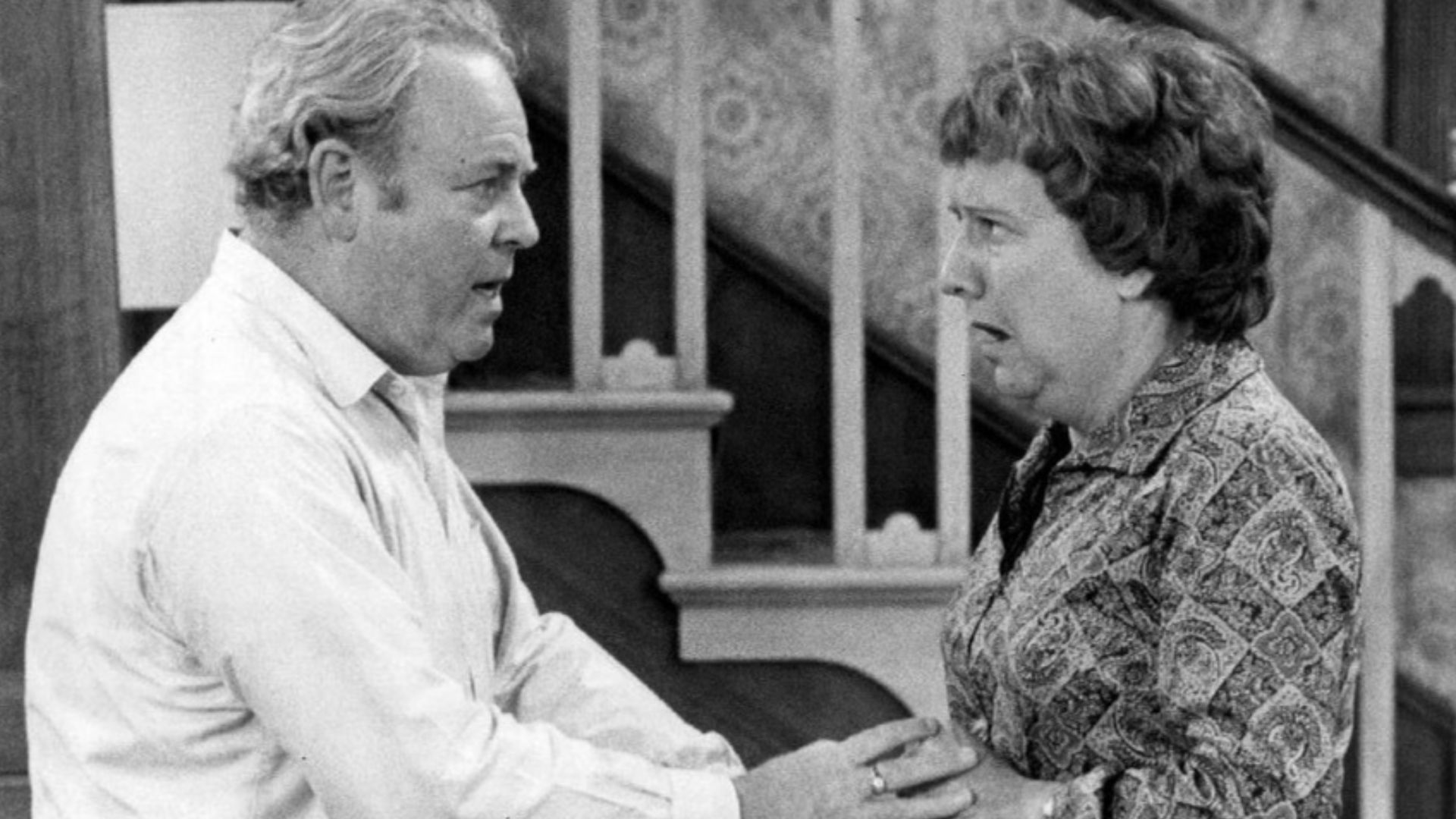 Photo of Carroll O'Connor and Jean Stapleton as Archie and Edith Bunker from the television program All In the Family.  When Archie comes home in a great mood with gifts for everyone in the family, happiness turns to shock and anger when it's discovered h