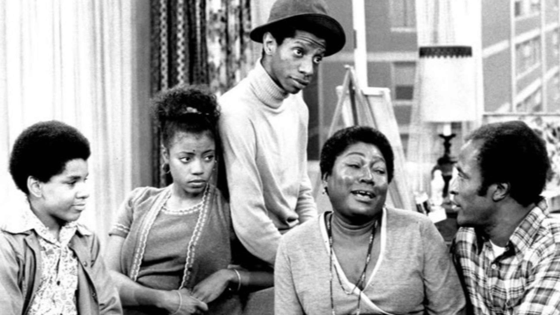 Photo of the Evans family from the television program Good Times.  From left: Ralph Carter (Michael), BernNadette Stanis (Thelma), Jimmie Walker (J.J.), Esther Rolle (Florida), John Amos (James).