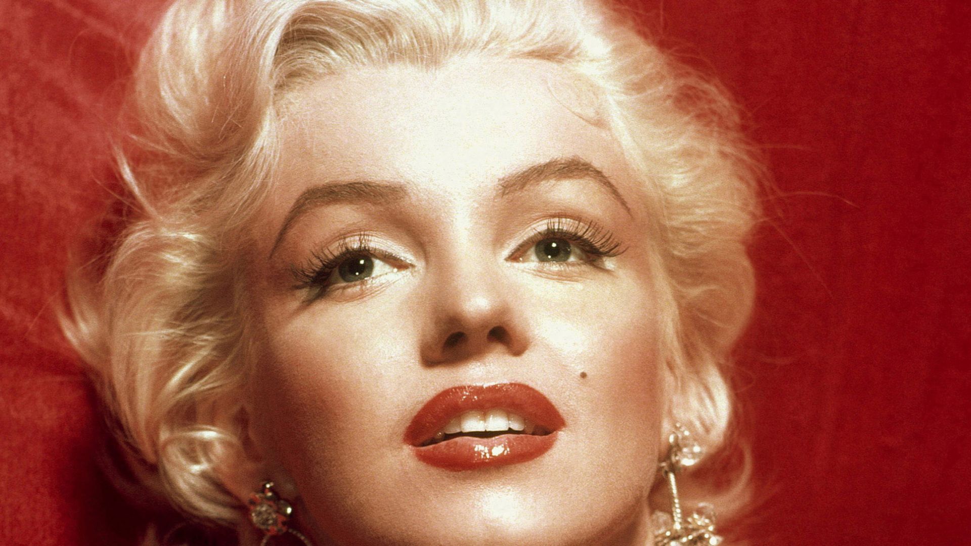 A glamorous Marilyn Monroe in a red dress, taken for publicity purposes for 1953 film How to Marry a Millionaire.