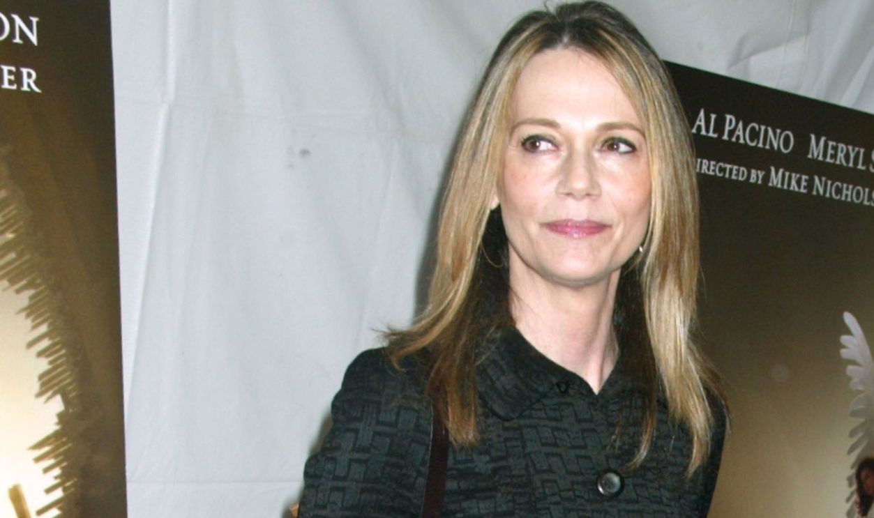 Peggy Lipton, wearing a coat designed by Donna Karan
