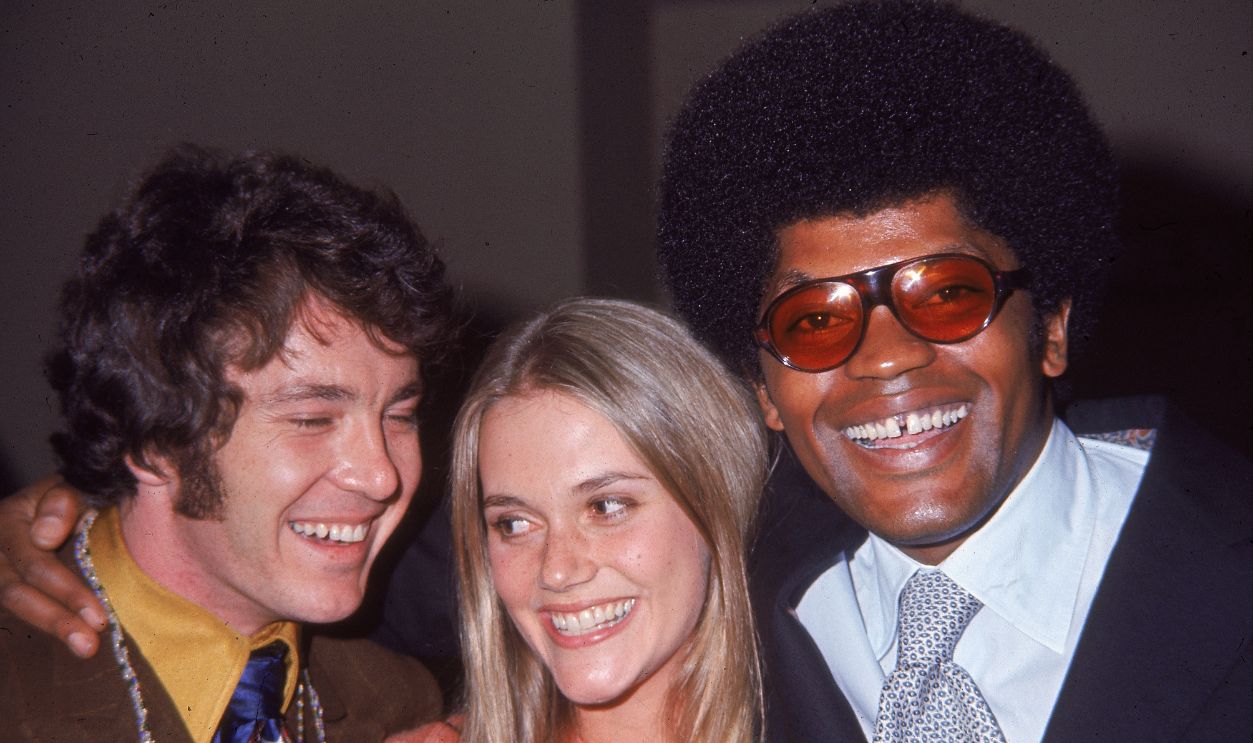American actors Michael Cole (left), Peggy Lipton and Clarence Williams III, all cast members from the television program, 'The Mod Squad,' smile while embracing