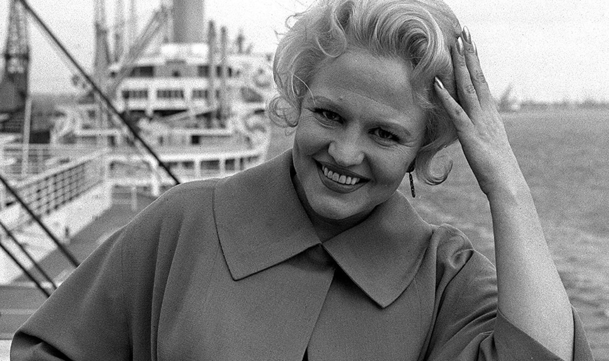 American sining star Peggy Lee as she arrives in Southampton from the USA to begin a three week season at the Pigalle in London. 22/01/02: American singing star Peggy Lee whose smoky voice in such songs as That All There Is? and Fever made her a jazz and pop legend, has died. *... it was announced. Lee died from a heart attack at her home in Bel Air, Los Angeles, said her daughter, Nicki Lee Foster. Lee repeatedly battled injury and ill health, including heart trouble, in order to maintain a career that brought her a Grammy, an Oscar nomination and sold-out houses worldwide. She was 81.