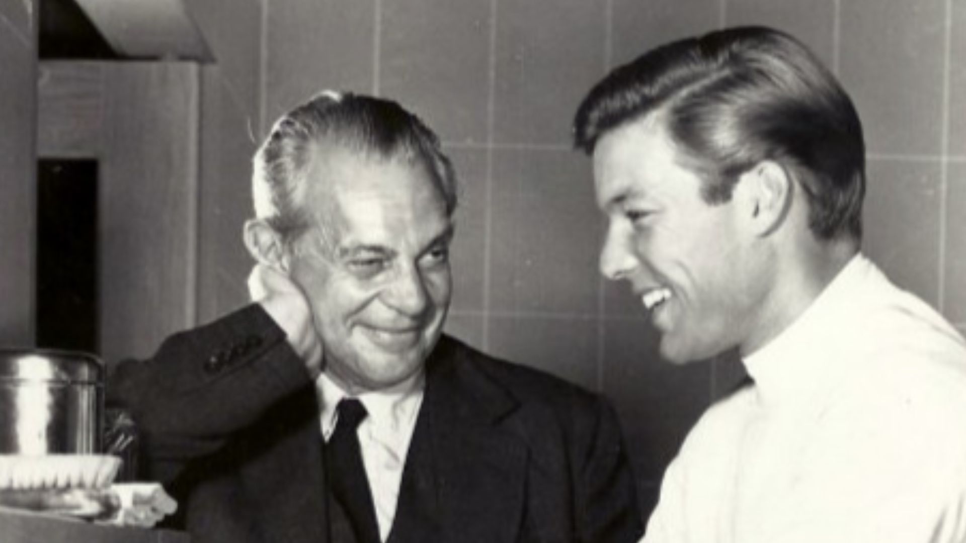 Publicity photo announcing the premiere of the television program Dr. Kildare.  Raymond Massey is Dr. Gillespie and Richard Chamberlain is Dr. Kildare, shown scrubbing up.