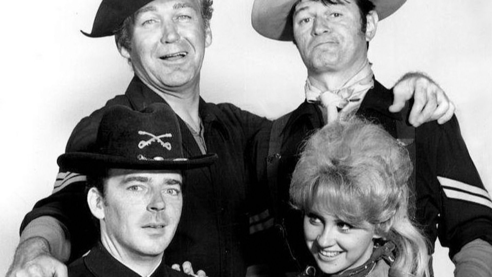 Main cast photo from the television program F Troop.  Standing from left: Forrest Tucker and Larry Storch. Seated: Ken Berry and Melody Patterson.