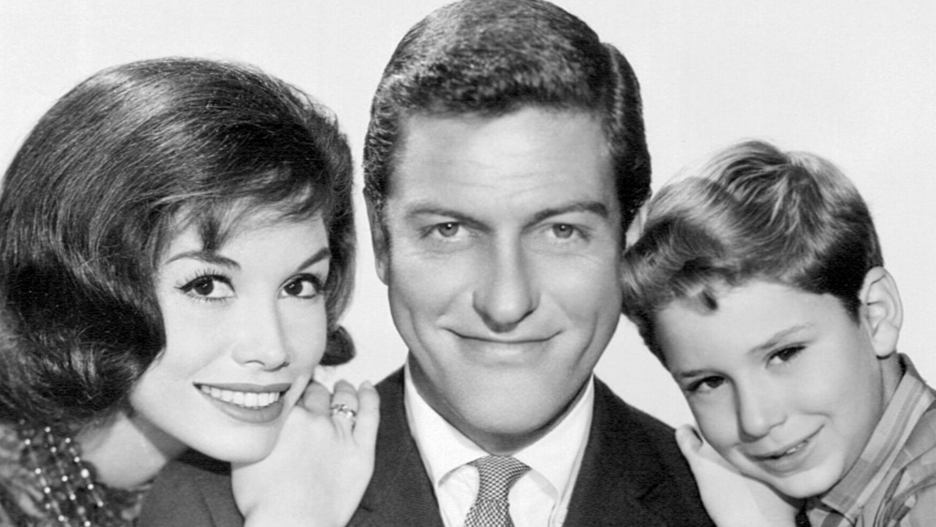 Photo of the Petrie family from the television program The Dick Van Dyke Show. From left-Mary Tyler Moore (Laura Petrie), Dick Van Dyke (Rob Petrie), Larry Mathews (Richie Petrie).