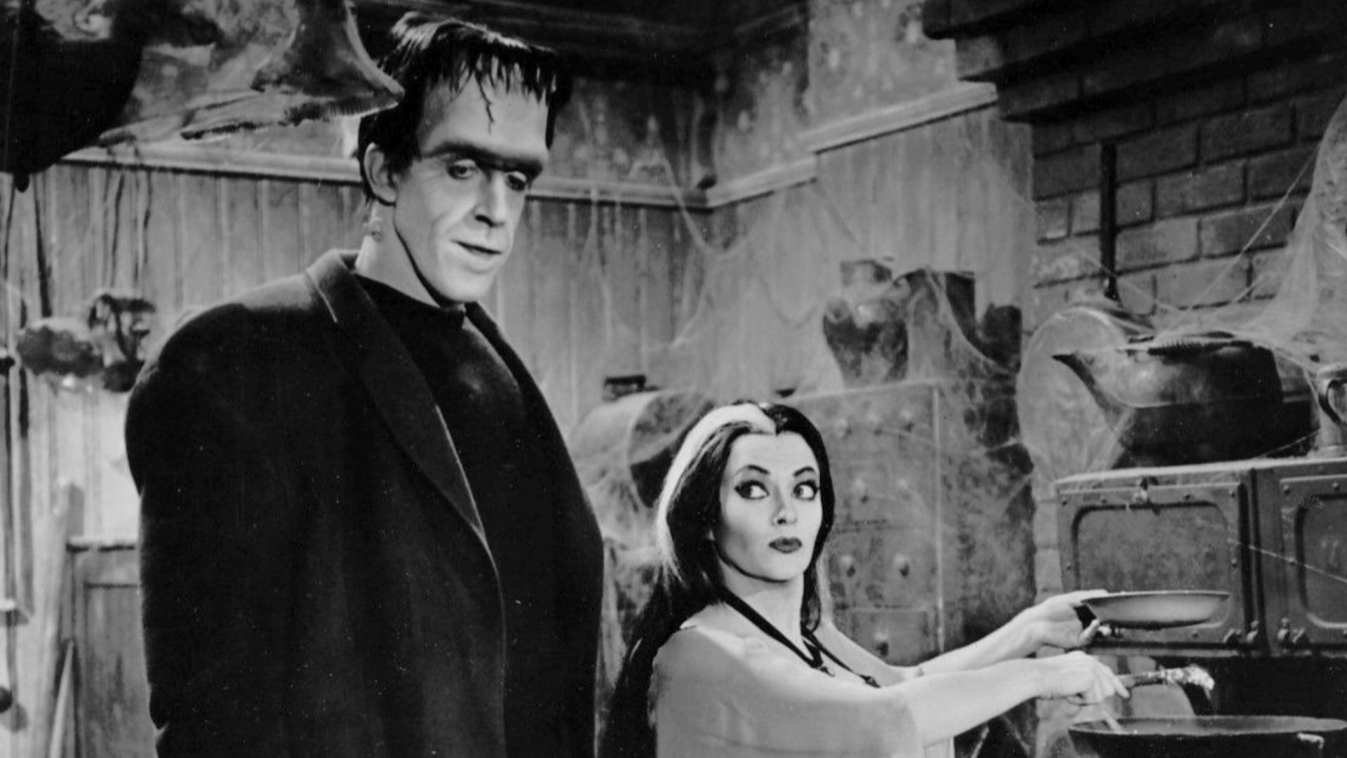 Photo of Fred Gwynne (Herman Munster) and Yvonne DeCarlo as his wife, Lily, from the television program The Munsters.