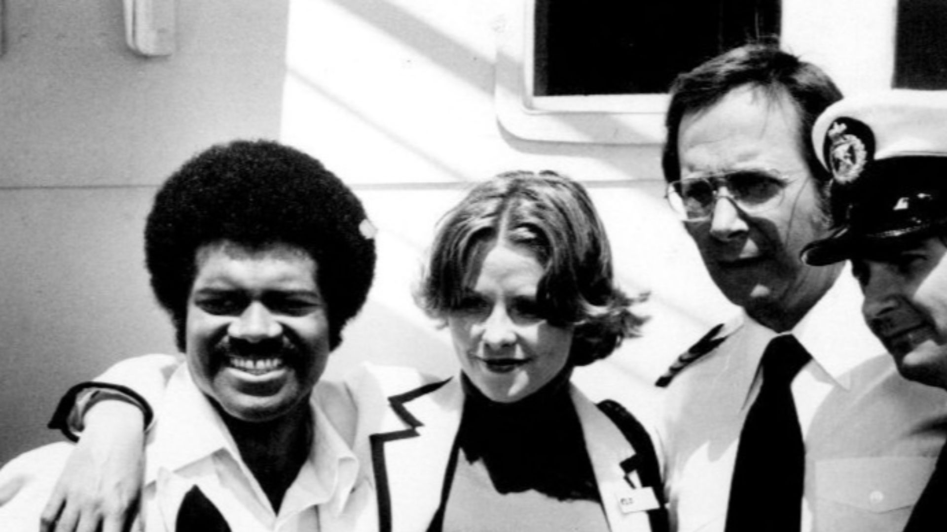 Photo of The Love Boat cast except Gavin MacLeod (Captain Stubing).  From left-Ted Lange (Isaac Washington), Lauren Tewes (Julie McCoy), Bernie Kopell (Adam Bricker), and Fred Grandy (Gopher).