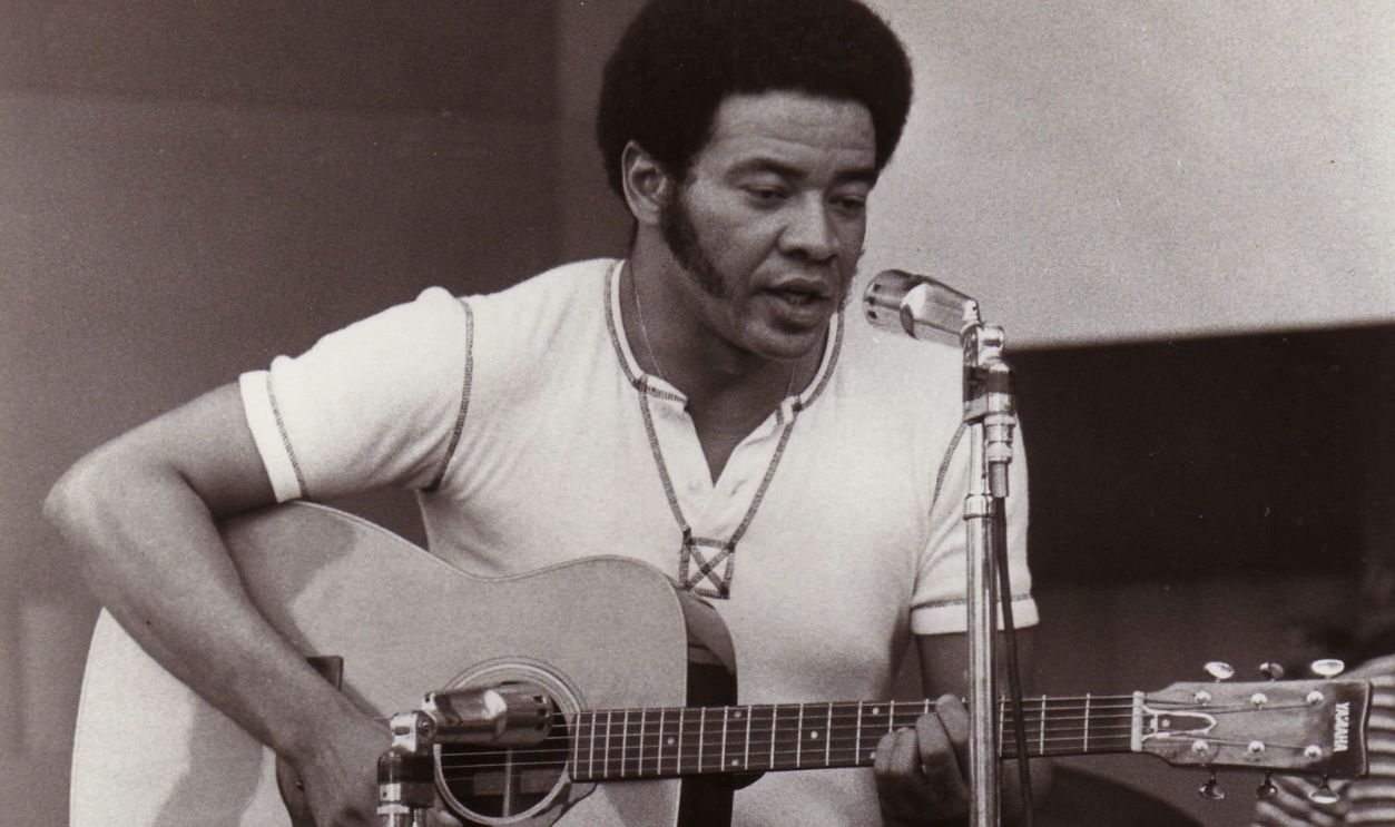 Bill Withers performs on stage in 1972. 