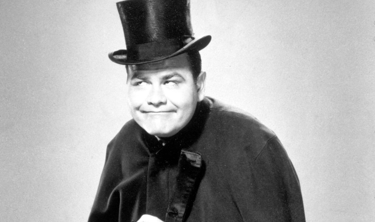 1955, Promotional studio portrait of American comedian Jonathan Winters making a face while wearing a cloak and top hat and holding a dagger.