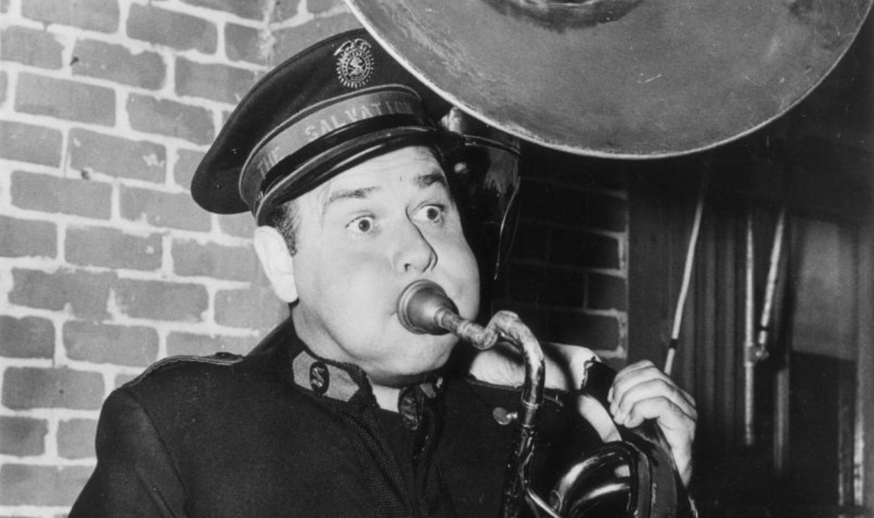 Dressed in a Salvation Army uniform and playing a tuba, actor-comic Jonathan Winters known as 'America's Jimmy Edwards' as he will appear in his latest film comedy with Rosalind Russell, 'Oh Dad, Poor Dad, Mamma's Hung You In The Closet and I'm Feeling So Sad'.