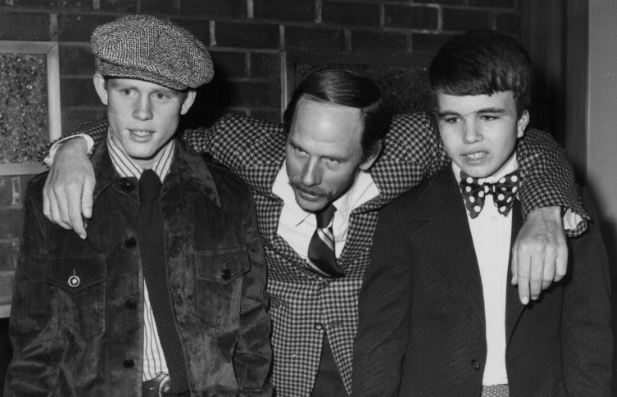 Actor Rance Howard with his arms around his sons Ron and Clint, also actors, at a screening of the movie 'Where the Lilies Bloom', at the Screen Directors Guild, Hollywood, February 1974.
