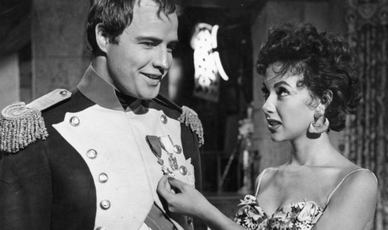 Marlon Brando and Rita Moreno visit on the set of the film 'Desiree', 1954.