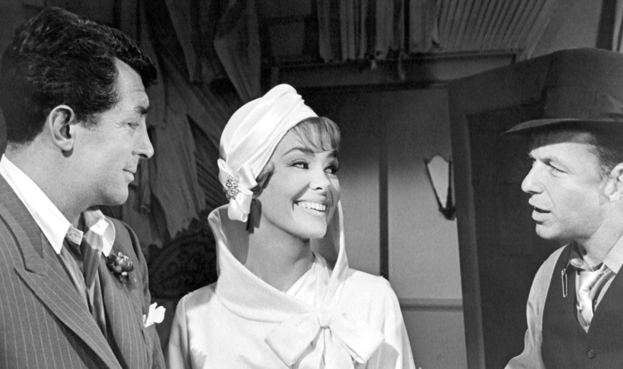 Dean Martin (1917 - 1995, left) as Little John, Barbara Rush as Marian Stevens and Frank Sinatra (1915 - 1998) as Robbo, in 'Robin And The 7 Hoods', directed by Gordon Douglas, 1964.
