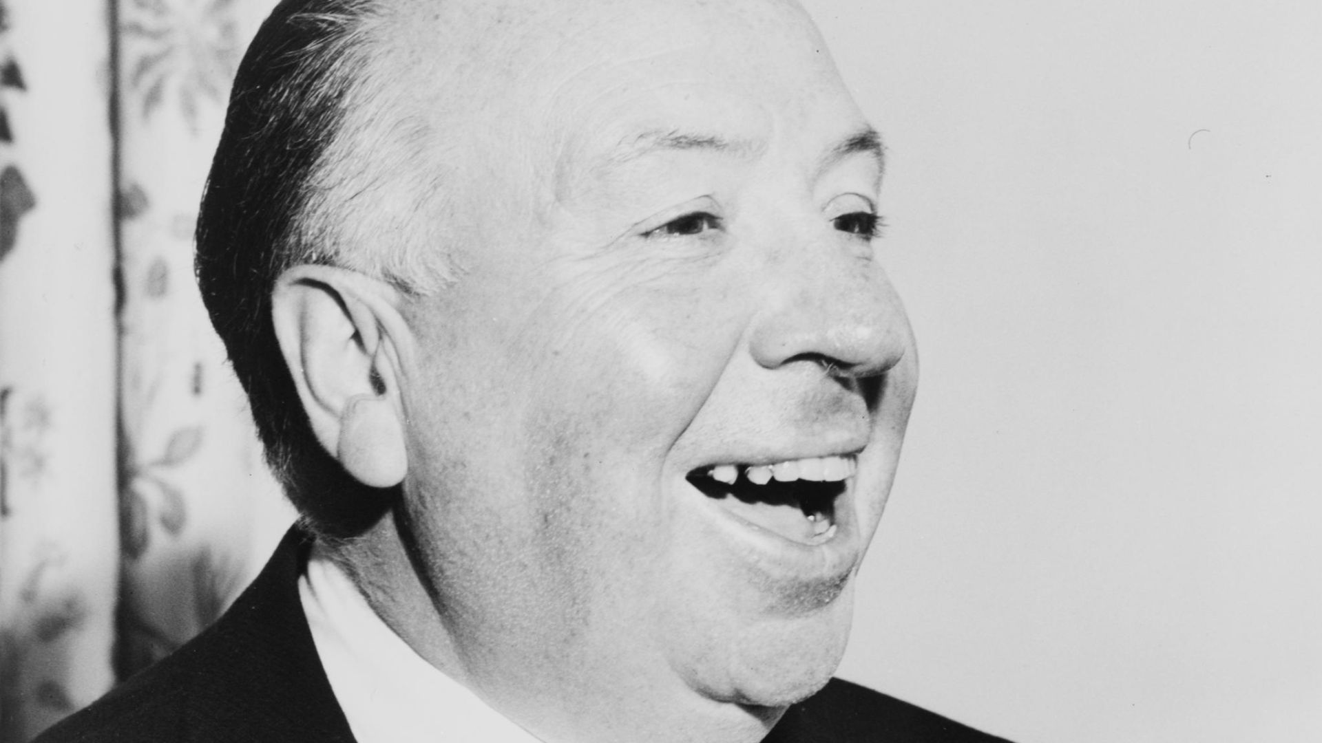 Alfred Hitchcock, head-and-shoulders portrait, facing right
