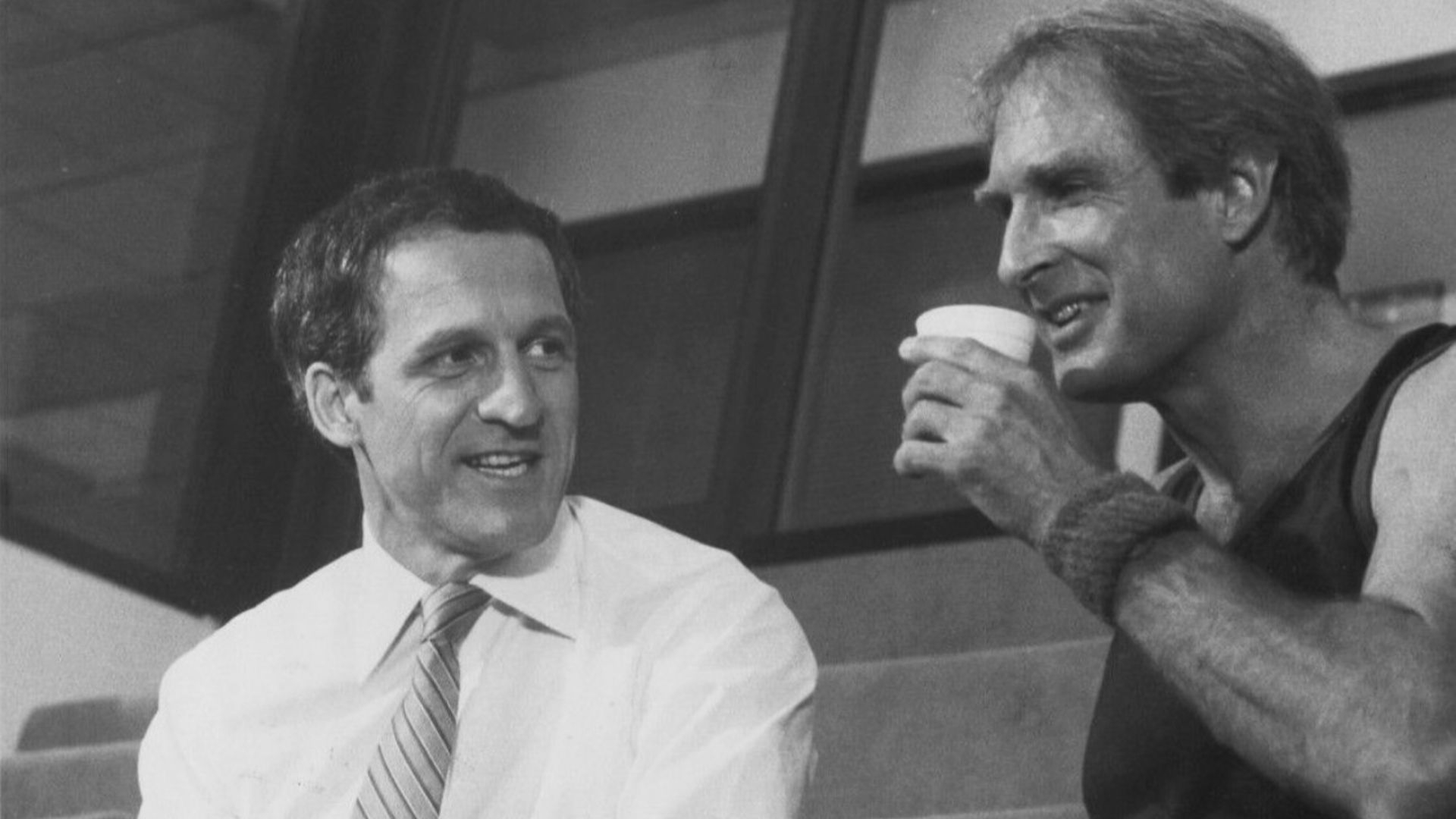 COFFEE AND CONFRONTATION--A battle looms behind the smiles and the coffee cup as Captain Furillo (Daniel J. Travanti, left) threatens to expose of politically sensitive police cover-up when he stands toe-to-toe with Chief Daniels (Jon Cypher) in