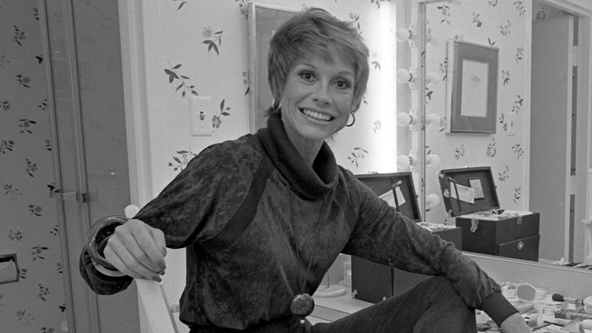 Actress Mary Tyler Moore sitting before dressing table