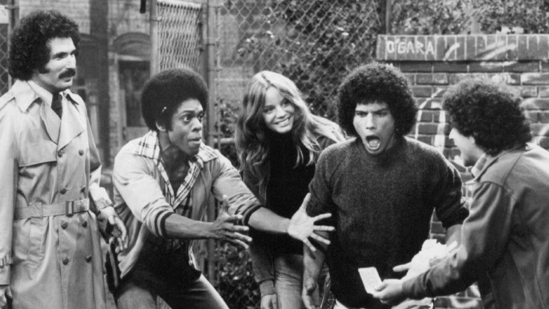 Publicity photo from the television program Welcome Back, Kotter. From left: Gabe Kaplan, Lawrence Hilton-Jacobs, Wendy Rastatter, Robert Hegyes, and Ron Palillo.  The Sweathogs are celebrating a winning New York State lottery ticket while Mr. Kotter look
