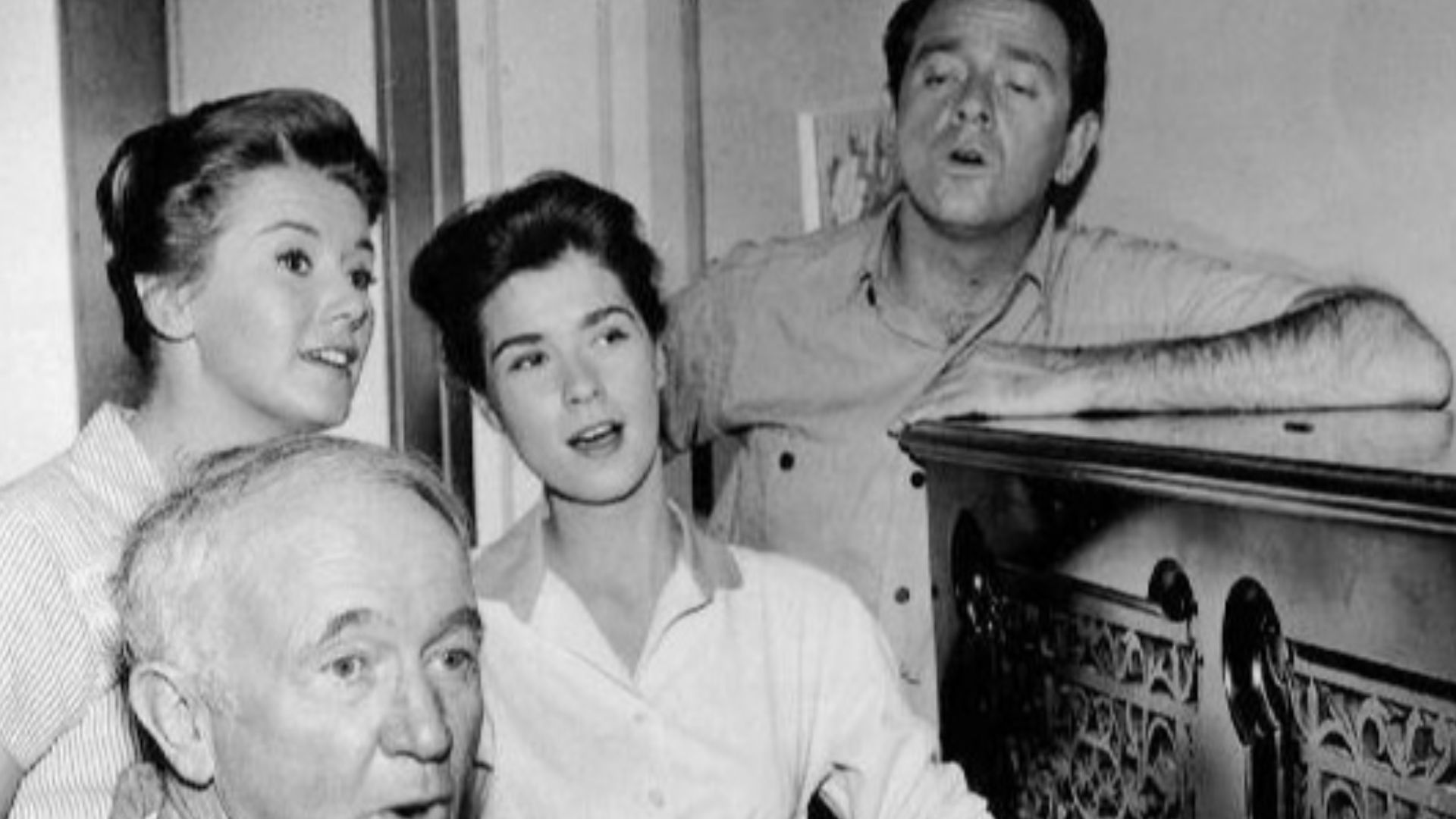 Photo of the McCoy family from the television program The Real McCoys.  Kate (Kathleen Nolan), Hassie (Lydia Reed) and Luke (Richard Crenna) join Grandpa Amos (Water Brennan) in song as he plays the family's new piano.