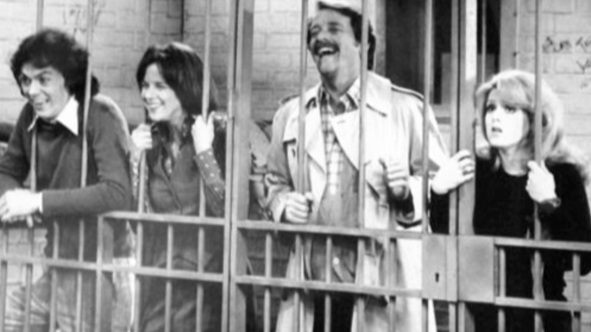 Photo from the television series All's Fair.  From left:Michael Keaton (Lanny Wolf), Judith Kahan (Ginger Livingston), Richard Crenna (Richard Barrington) and Bernadette Peters (Charley Drake).