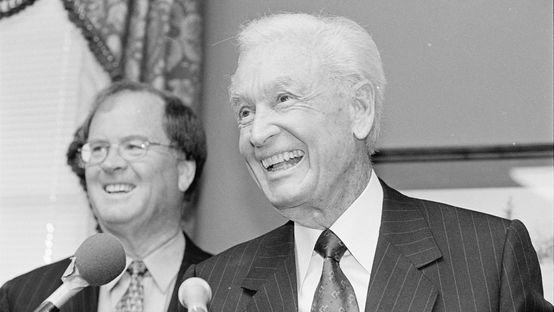 Television game show host Bob Barker speaking with U.S. Representative Sam Farr behind him