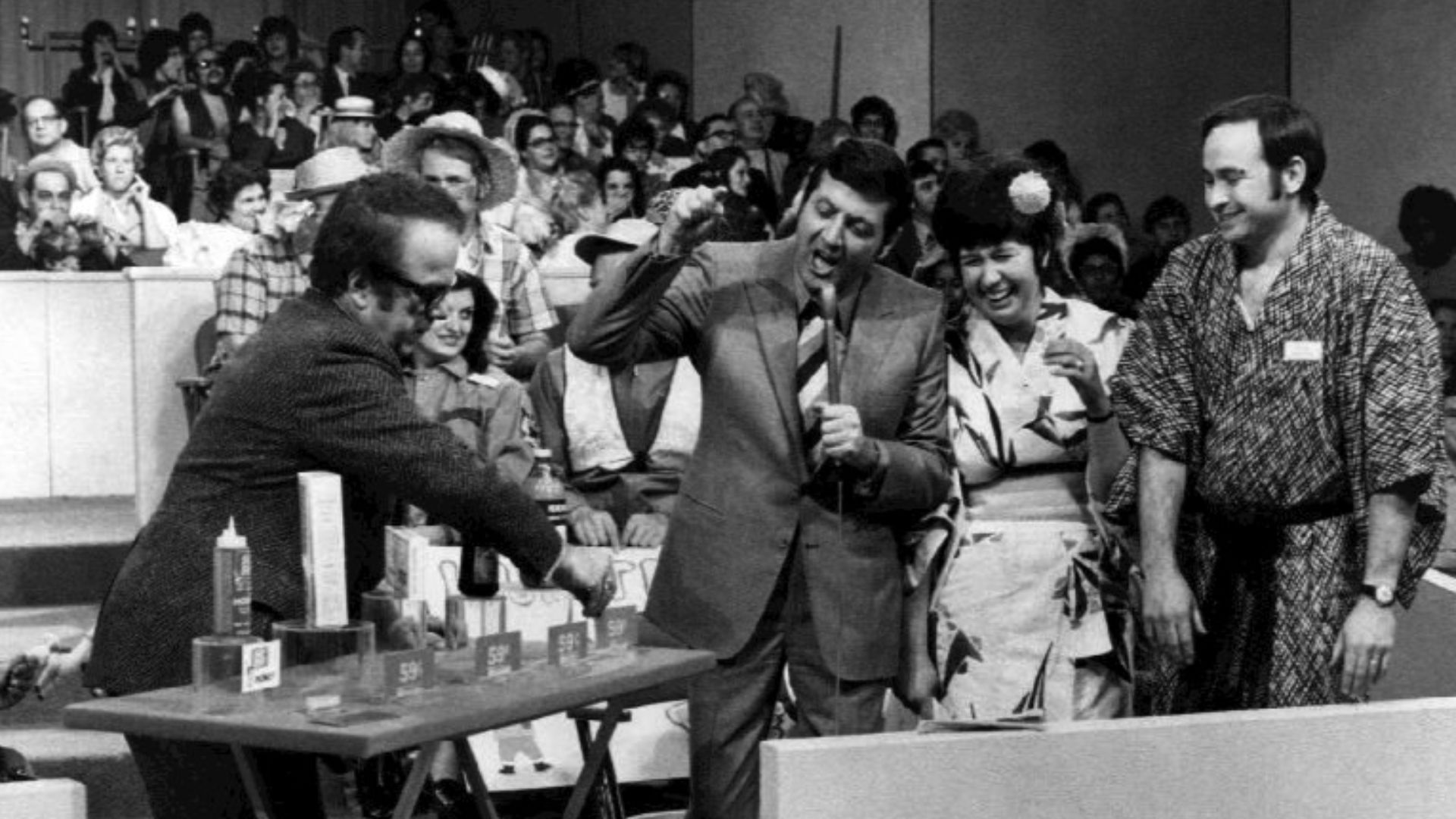 Publicity photo from the television show Let's Make a Deal. Pictured are host Monty Hall and announcer Jay Stewart with contestants.
