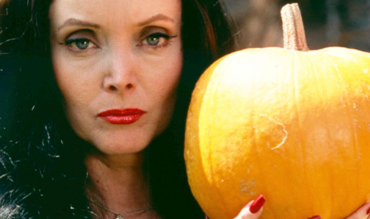 Carolyn Jones [1930-1983), US actress, in costume and holding a pumpkin in a publicity portrait issued for the US television series, 'The Addams Family', USA, circa 1965. The sitcom starred Jones as 'Morticia Frump Addams'. 