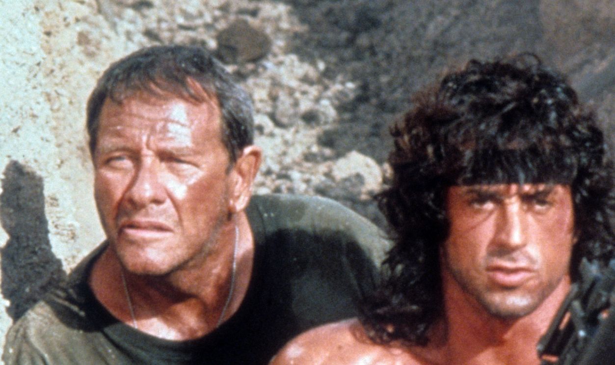 Getty Images - 168583121 - Sylvester Stallone walks through a trench with Richard Crenna in a scene from the film 'Rambo III', 1988.
