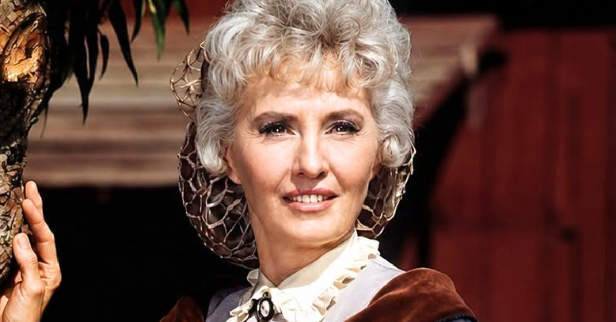 Barbara Stanwyck period costume posing beside a tree in an image issued as publicity for the US television series, 'The Big Valley', circa 1967. The Western drama starred Stanwyck as 'Victoria Barkley'.