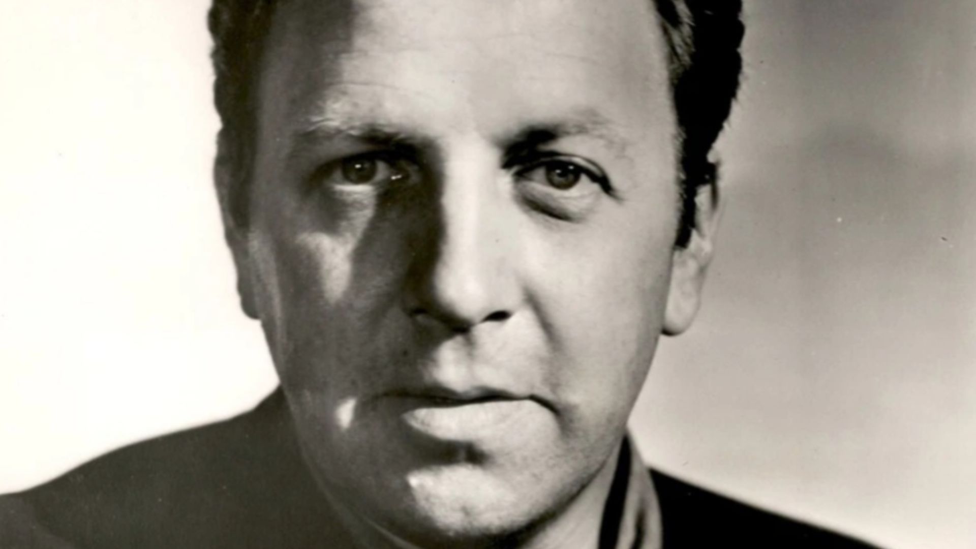 This is a publicity photo, circulated for publicity, of Robert Foulk, published in 1960 without copyright notice, qualifying it under public domain.