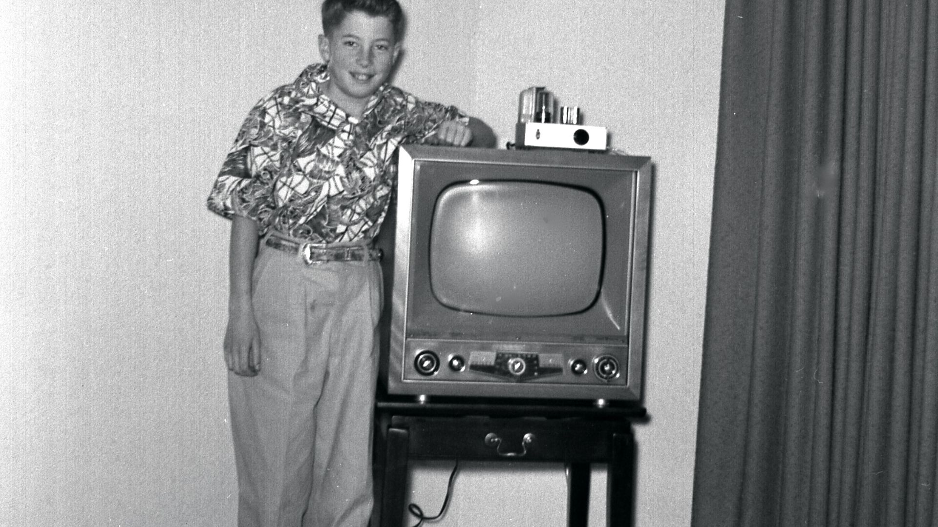 We got the set in late 1952 or early 1953;  the photo is probably from the same time and was taken in Eugene, Oregon (USA).  Until a local station started broadcasting, we only got a very fuzzy picture from a UHF station in Portland. The cable going off t