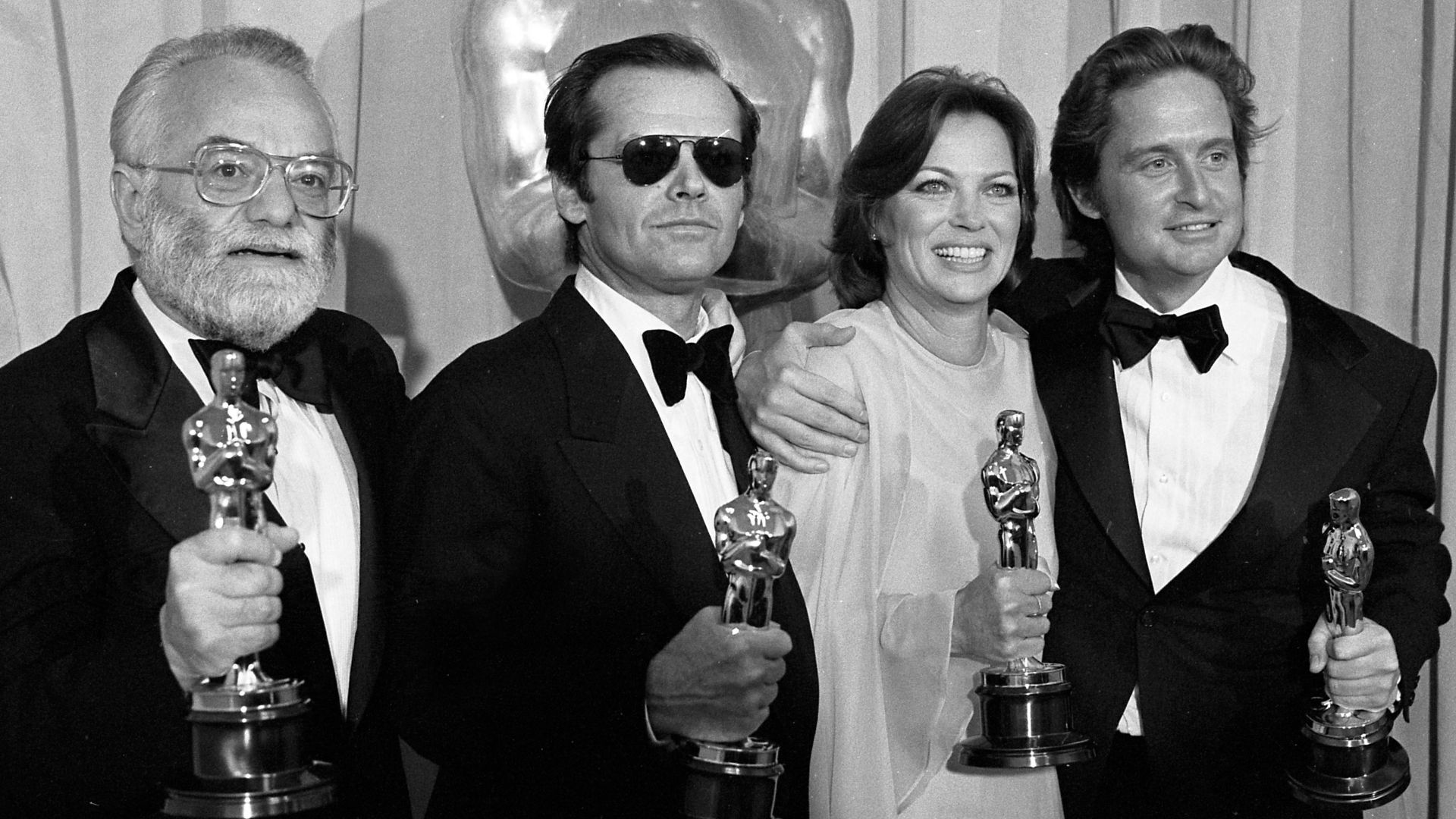 Saul Zaentz, Jack Nicholson, Louise Fletcher and Michael Douglas posing with their Oscars at the 1976 Academy Awards on March 30, 1976