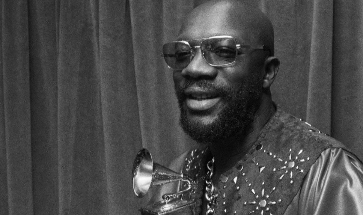 Photo of Isaac Hayes holding his Grammy award for Shaft in 1972