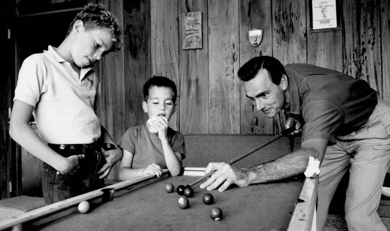 Actor Dennis Weaver plays pool with his sons Rick Weaver and Robby Weaver at home in 1958.