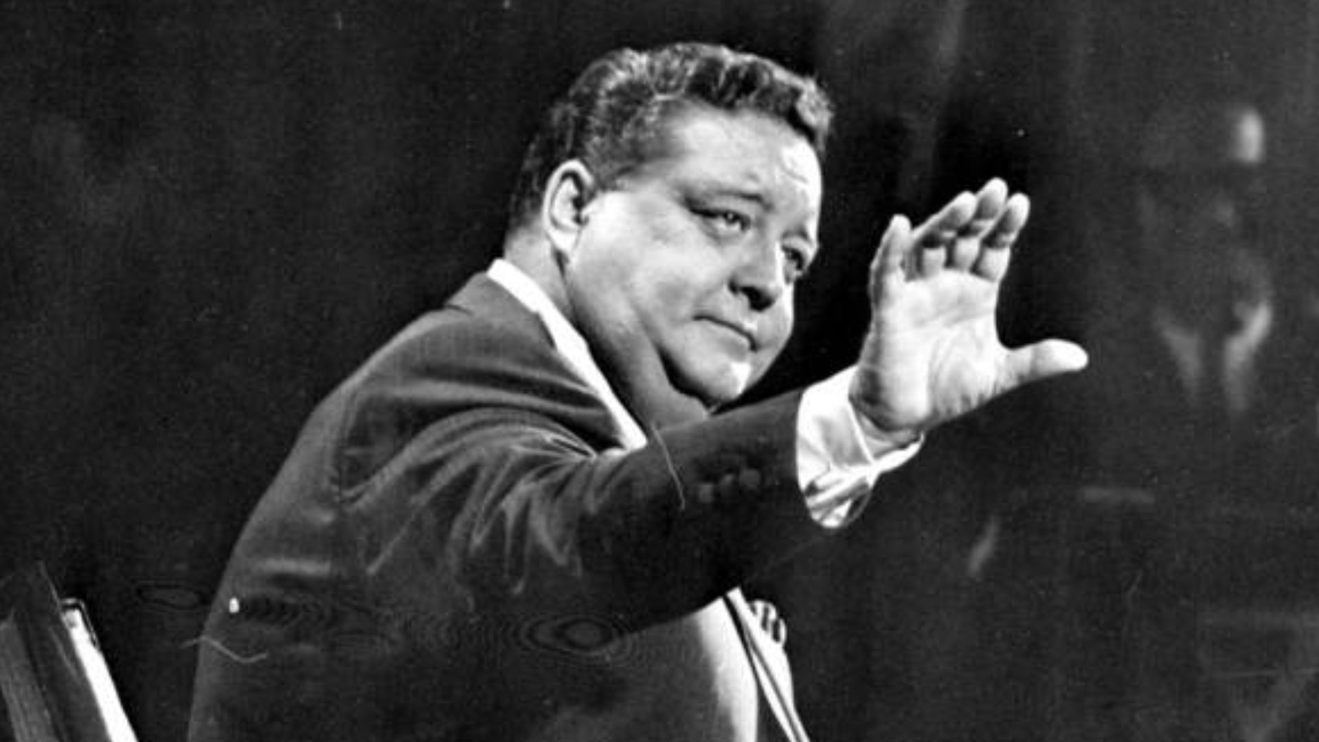 Medium shot of John Herbert Gleason sitting on a set