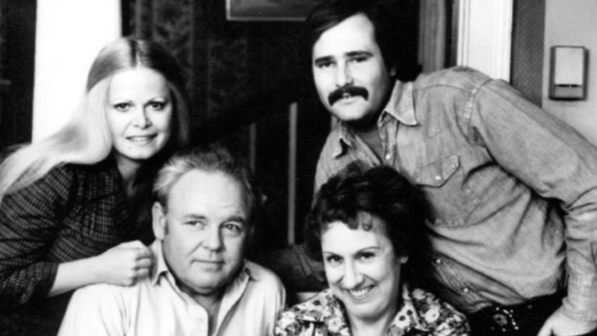 Photo of the Cast of the television program All in the Family.  Standing are Sally Struthers (Gloria) and Rob Reiner (Michael); seated are Archie (Carroll O'Connor) and Edith (Jean Stapleton), who is holding the child who played the Bunker's grandson, Joe