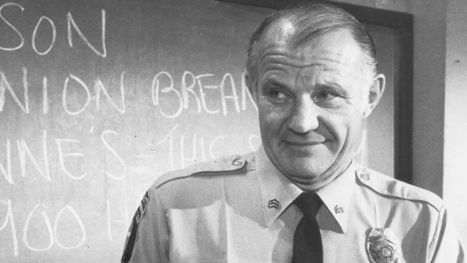 ESTERHAUS OF HILL STREET - Sergeant Esterhaus, Micheal Conrad reverently holds the urn containing ashes of the recently deceased telephone repairman at the station, in