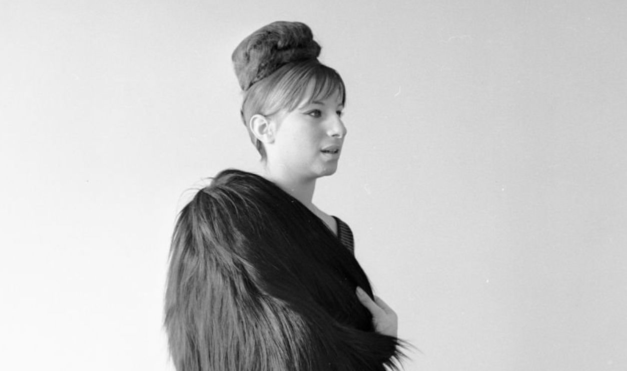 Actress and singer Barbara Streisand poses for Tony Palmieri in some of her vintage and second-hand items purchased before she gained fame in 'Funny Girl,' shown here-- a fur wrap and long over coat with an twisted up-do...Article title: 'Barbra