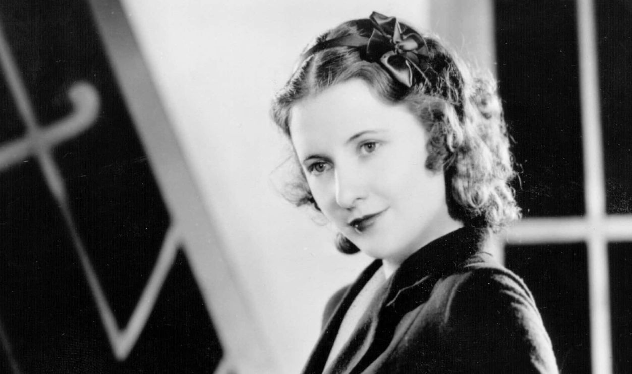 Barbara Stanwyck red-haired American actress in black top