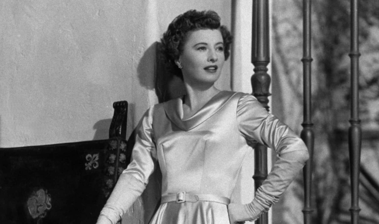Barbara Stanwyck, the Hollywood actress, in a satin evening dress