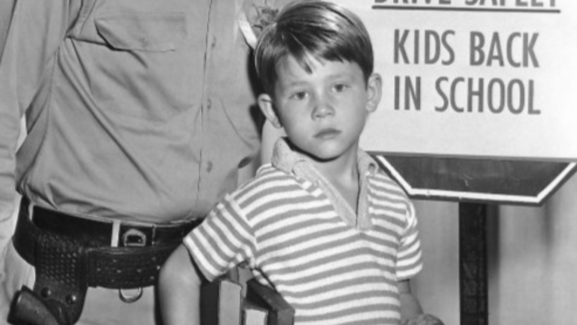 Publicity photo of Andy Griffith and Ron Howard from the television program The Andy Griffith Show.  The photo was to remind people when the show would return to the air with new episodes and to be careful driving because it was now school time.