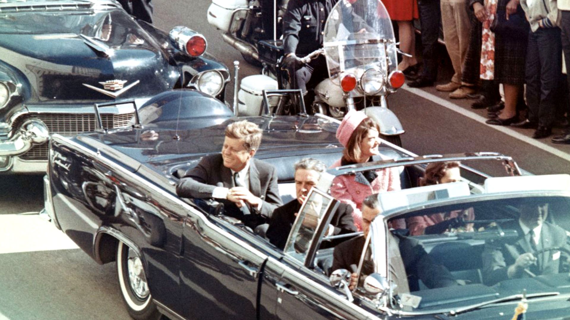 Picture of President Kennedy in the limousine in Dallas, Texas, on Main Street, minutes before the assassination.  Also in the presidential limousine are Jackie Kennedy, Texas Governor John Connally, and his wife, Nellie.