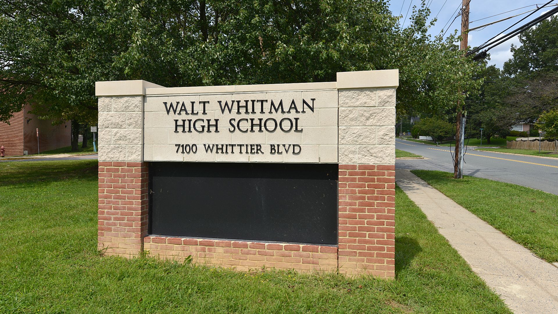 The sign at the road for Walt Whitman High School,  part of the Montgomery County Public Schools system. 7100 Whittier Blvd, Bethesda, Maryland 20817.